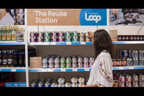 Woman picking up product from Tesco Loop range